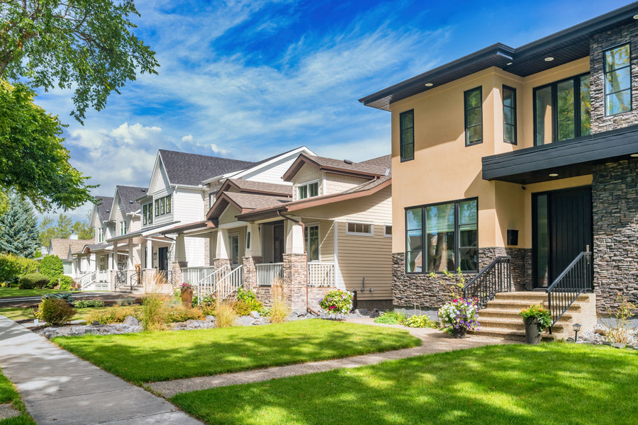 Older and newer homes along a tree-lined street in Westmount, Edmonton, Alberta